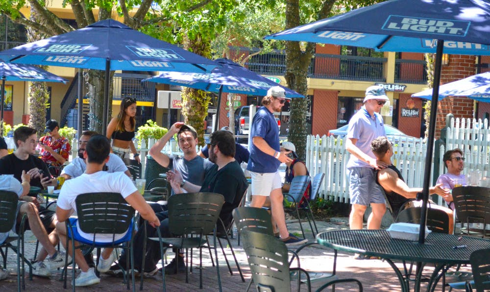 People gather at The Swamp Restaurant May 5, one day after Gov. Ron Desantis began to re-open the state economy. 