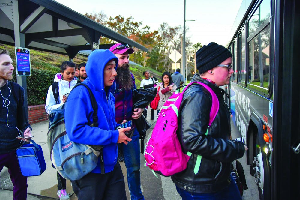 A group of passengers wearing heavy jackets and long pants board a Regional Transit System bus on Newell Drive on Monday, Jan. 9, 2017. At the time, the temperature was already in the mid-50s and predicted to drop later that night.