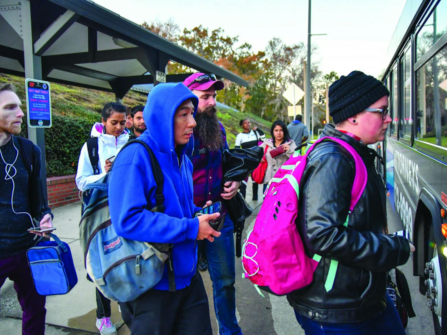 A group of passengers wearing heavy jackets and long pants board a Regional Transit System bus on Newell Drive on Monday, Jan. 9, 2017. At the time, the temperature was already in the mid-50s and predicted to drop later that night.