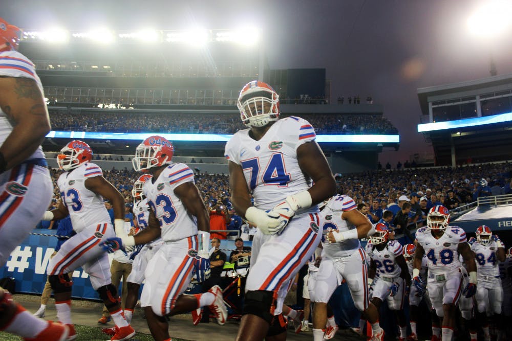 <p>UF offensive lineman Fred Johnson (74) screams in excitement as he runs out of the tunnel prior to Florida's 14-9 win against Kentucky on Sept. 19, 2015, at Commonwealth Stadium in Lexington, Kentucky.</p>