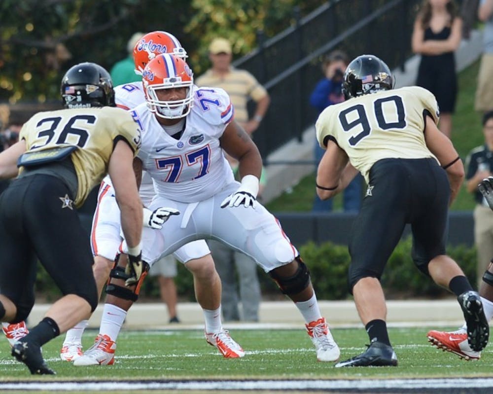 <p>Guard Ian Silberman (77) blocks for quarterback Jeff Driskel against Vanderbilt in 2012. Silberman will transfer from Florida and will play out his final season of eligibility elsewhere next season.&nbsp;</p>
