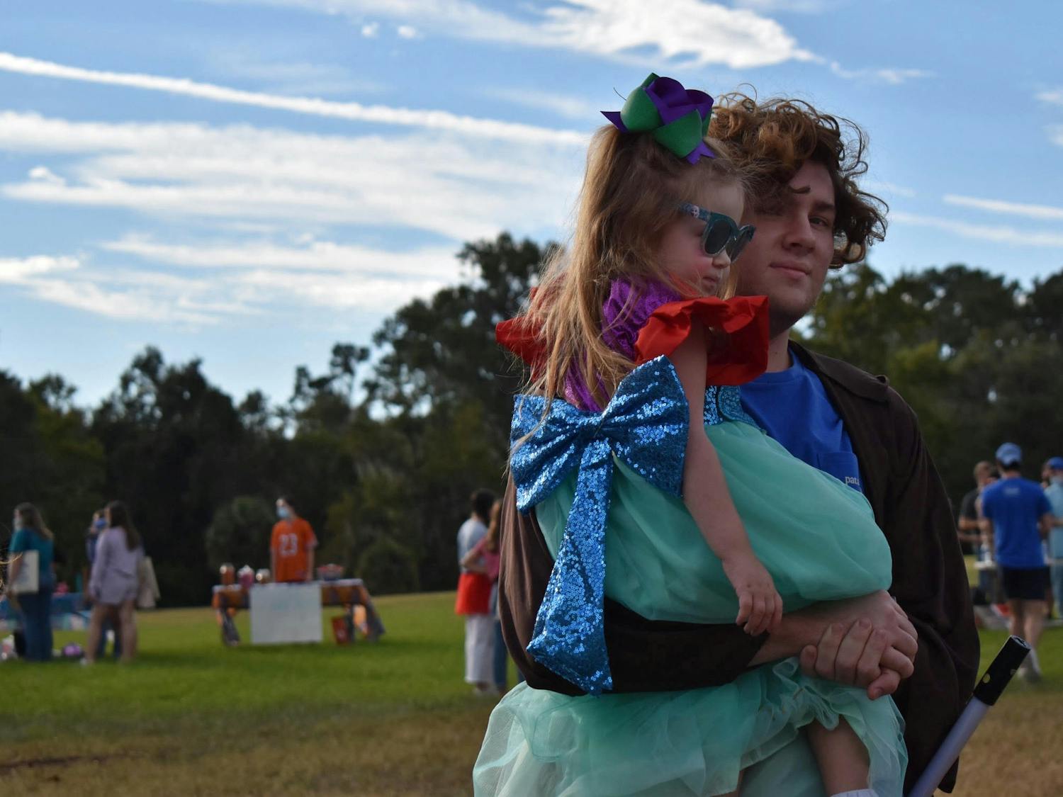 Hannah Strickland, 5, surveys the festivities in her Princess Ariel costume during Dance Marathon at UF's Moralloween event at Flavet Field on Wednesday, Oct. 27, 2021. 