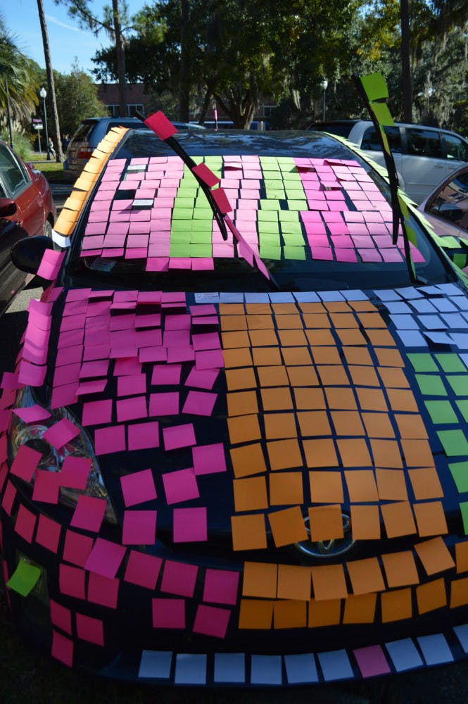 A car outside the Student Health Care Center was covered in sticky notes by UF Honors students as part of a prank on their adviser. They wrote jokes on sticky notes about the experience of being a freshman in the Honors program.