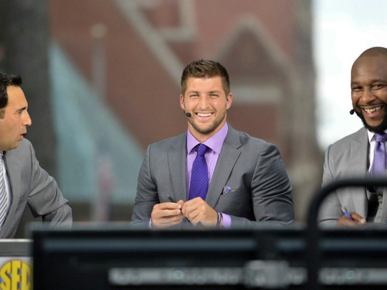 SEC Network's Joe Tessitore (left), Tim Tebow (center) and Marcus Spears (right) on the SEC Nation set located on UF's Plaza of the Americas on Friday.