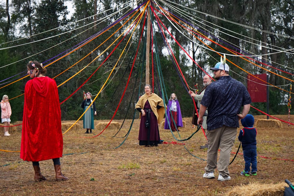 <p>Standing at the center of the maypole activity, a worker at the Hoggetowne Medieval Faire gives directions to the crowd Saturday, Jan. 21, 2023.</p>