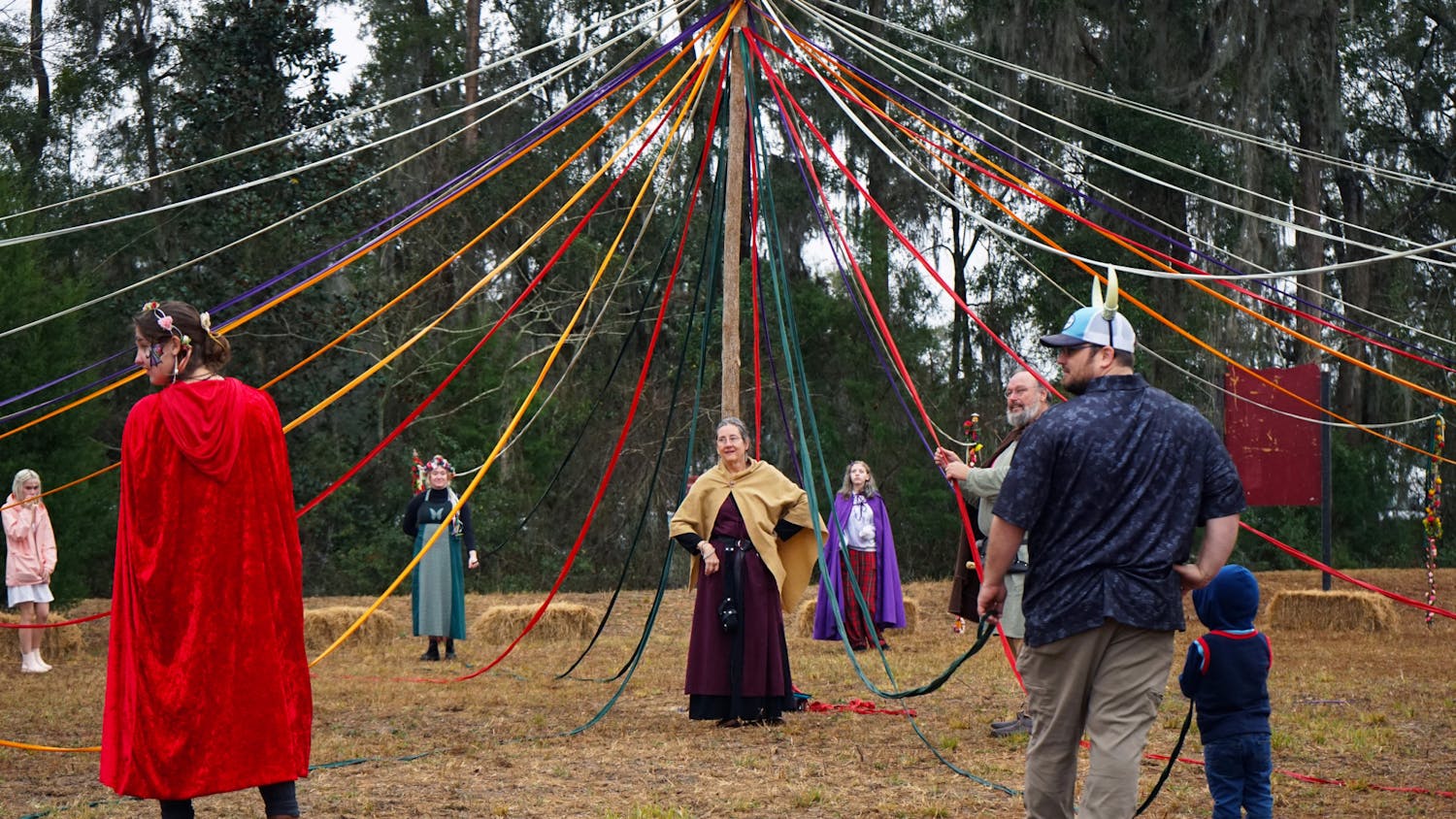 Standing at the center of the maypole activity, a worker at the Hoggetowne Medieval Faire gives directions to the crowd Saturday, Jan. 21, 2023.