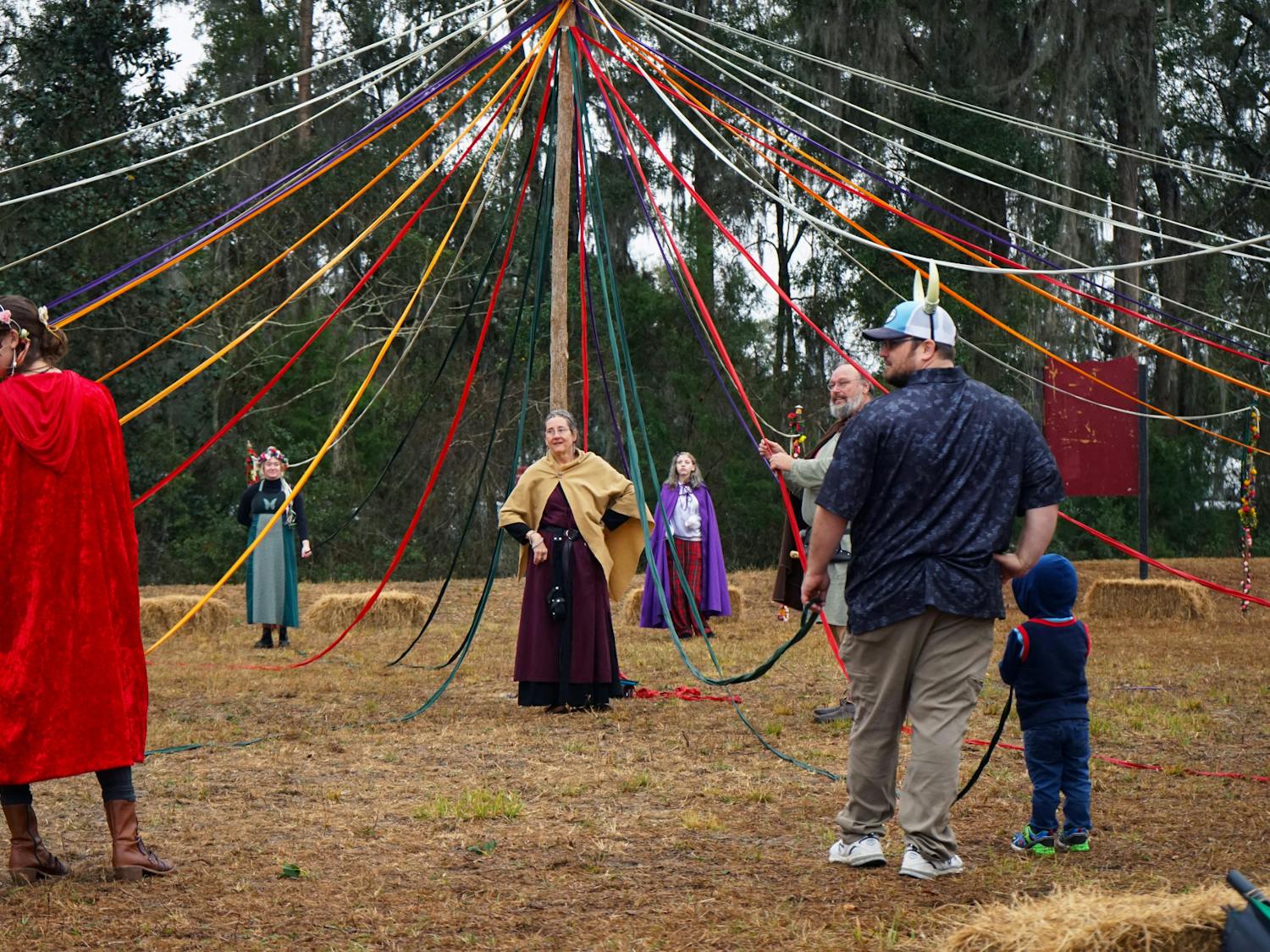 Standing at the center of the maypole activity, a worker at the Hoggetowne Medieval Faire gives directions to the crowd Saturday, Jan. 21, 2023.