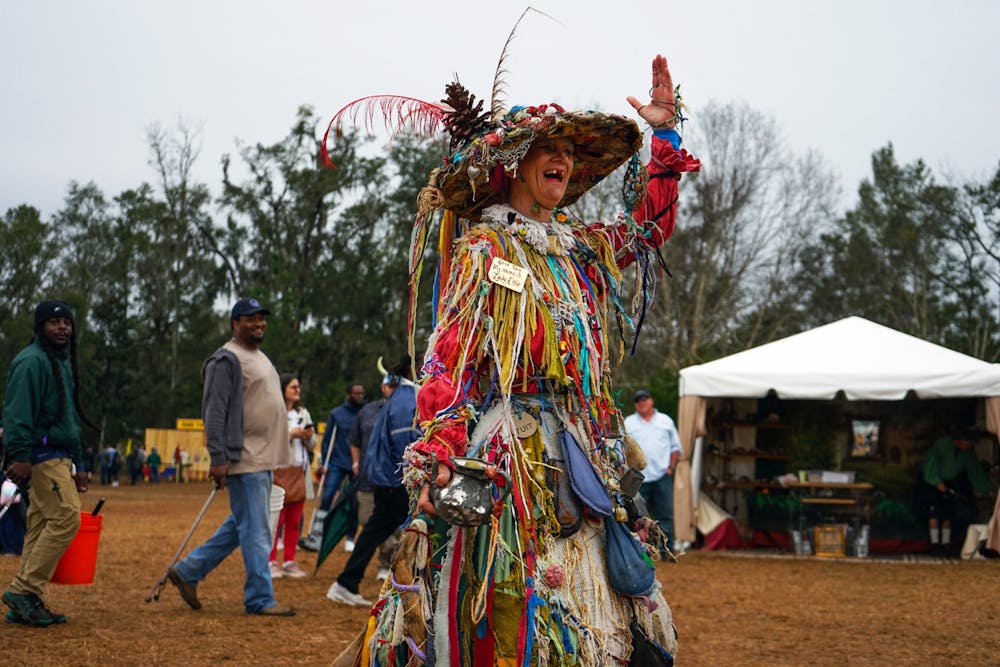 <p>Lady Ettie waves to onlookers while walking in a parade around the Hoggetowne Medieval Faire Saturday, Jan. 21, 2023.</p>