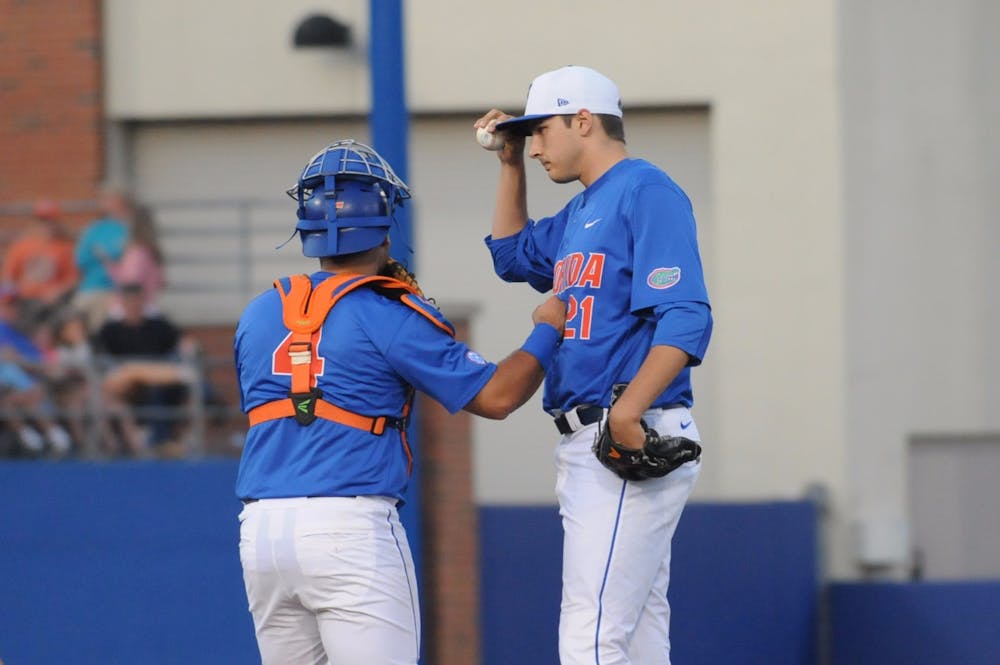 <p>Catcher Mike Rivera talks with pitcher Alex Faedo on the mound during Florida's 10-4 loss to Mississippi State on April 9, 2016, at McKethan Stadium.</p>