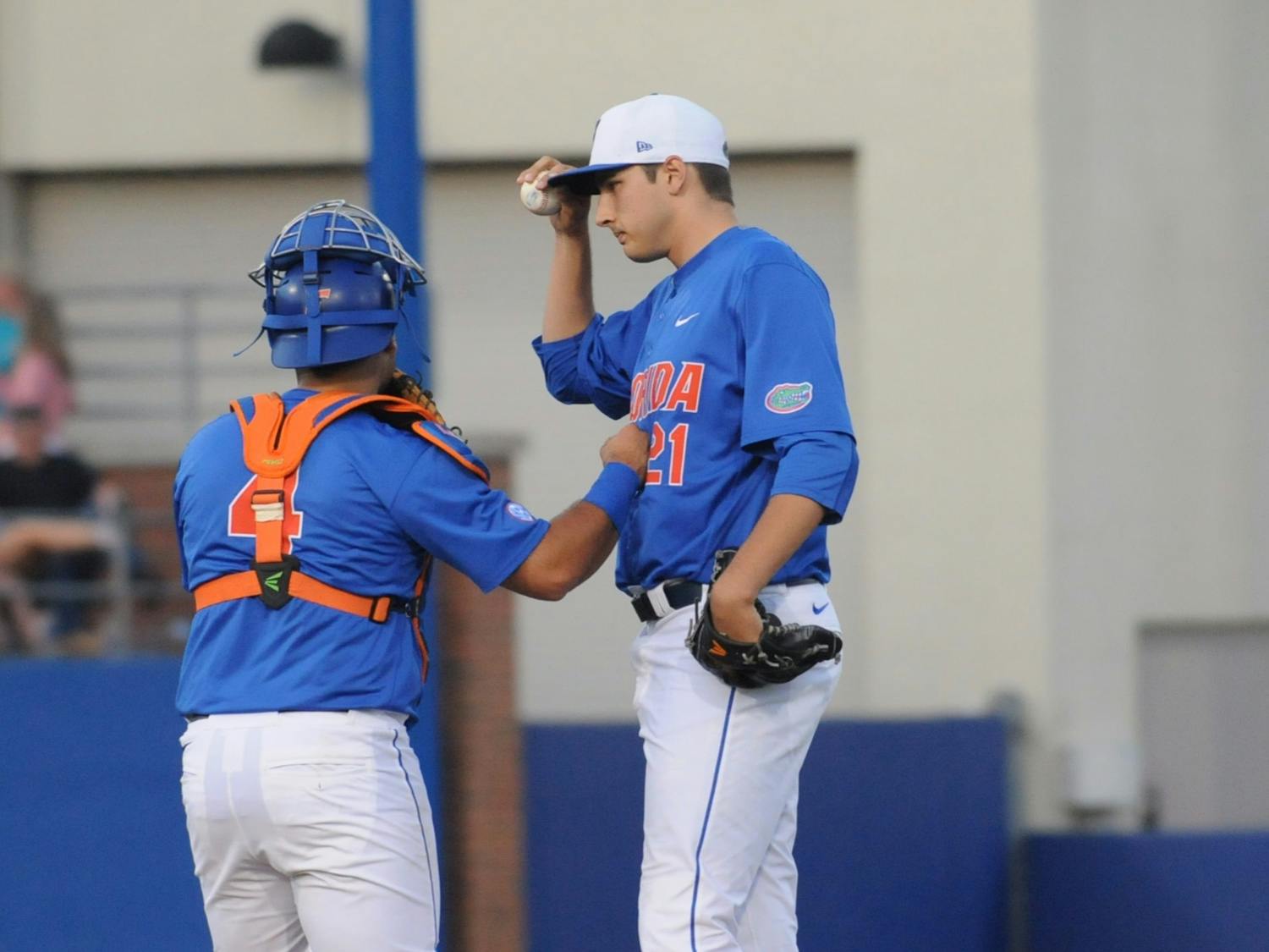 Catcher Mike Rivera talks with pitcher Alex Faedo on the mound during Florida's 10-4 loss to Mississippi State on April 9, 2016, at McKethan Stadium.