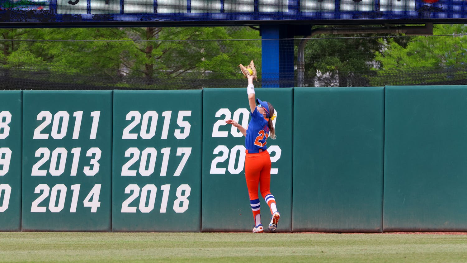 Florida outfielder Kendra Falby jumps and catches a ball in the outfield in the Gators' 8-7 win against the Georgia Bulldogs Saturday, April 15, 2023. 