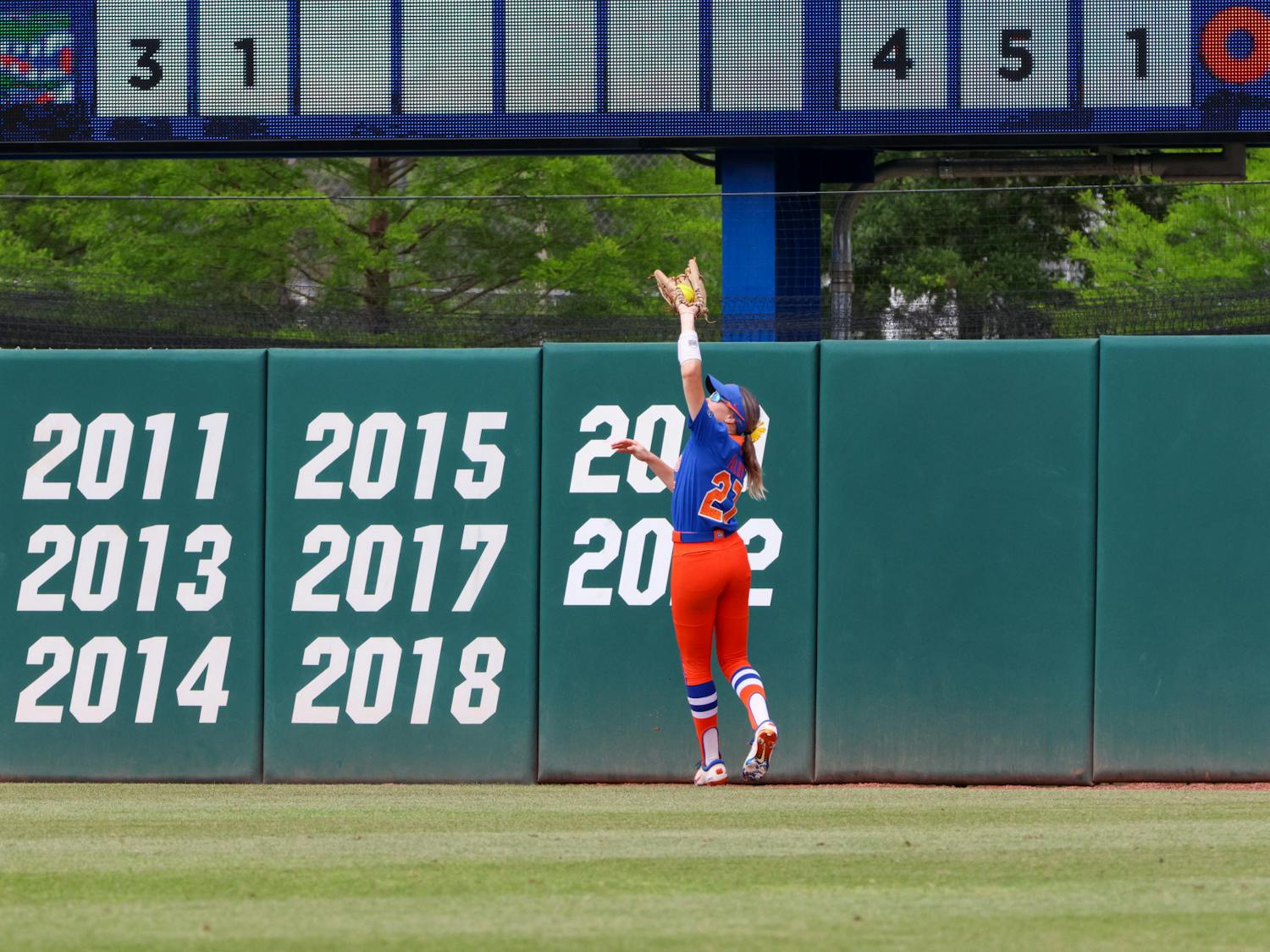 Florida outfielder Kendra Falby jumps and catches a ball in the outfield in the Gators' 8-7 win against the Georgia Bulldogs Saturday, April 15, 2023. 