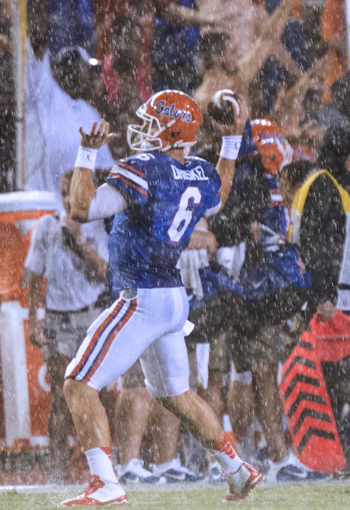 Jeff Driskel warms up in the rain before Florida's suspended game against Idaho on Saturday in Ben Hill Griffin Stadium.
