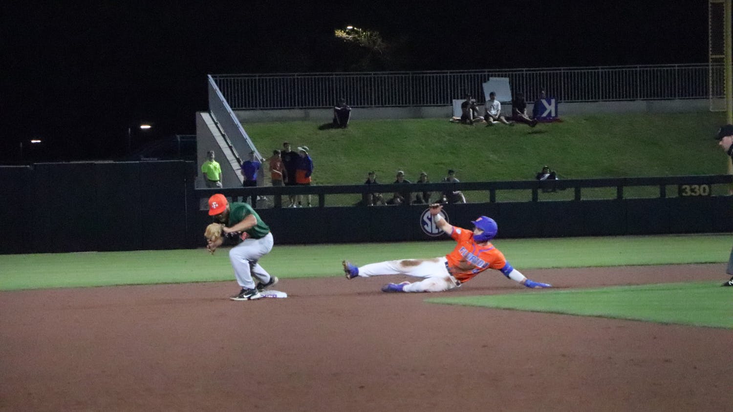 Florida center fielder Jud Fabian makes a slide for second base against Florida A&amp;M. His home run against Georgia ended up falling short, as the Bulldogs would walk off the game in the bottom of the ninth.