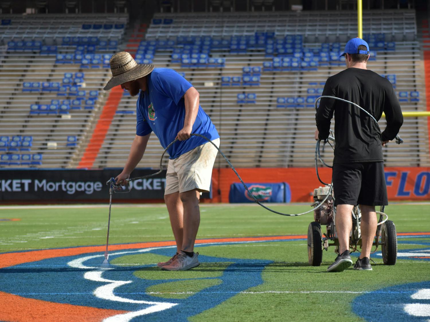 Field maintenance staff add the final touches to the Steve Spurrier-Florida Field in preparation for game day on Friday, Sept. 3, 2021.