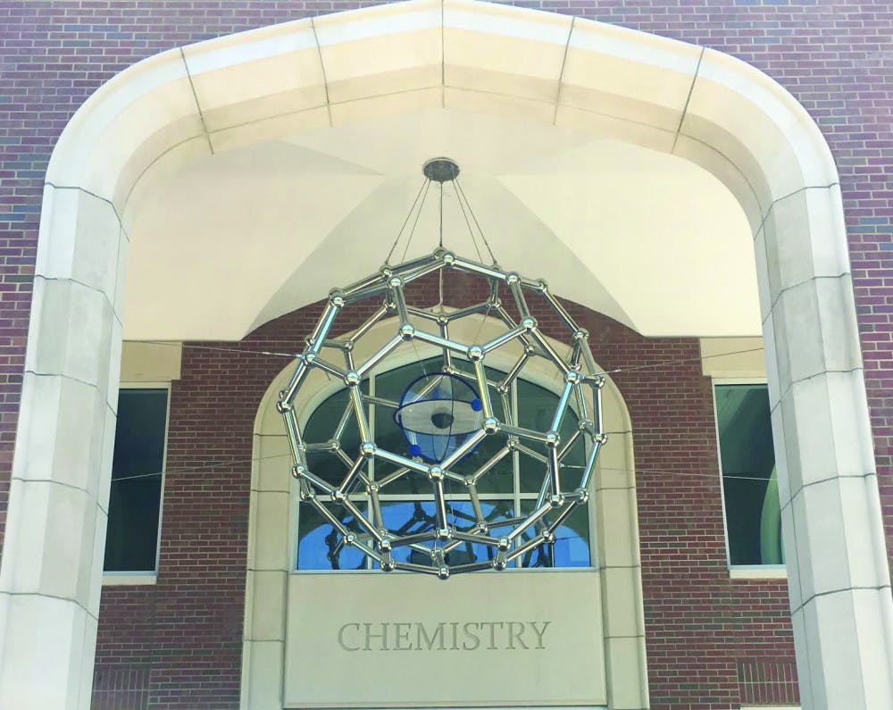 A 650-pound sculpture depicting a form of carbon is suspended by six steel cables over the entrance of Joseph Hernandez Hall, a $66.6 million building that was officially unveiled April 21.