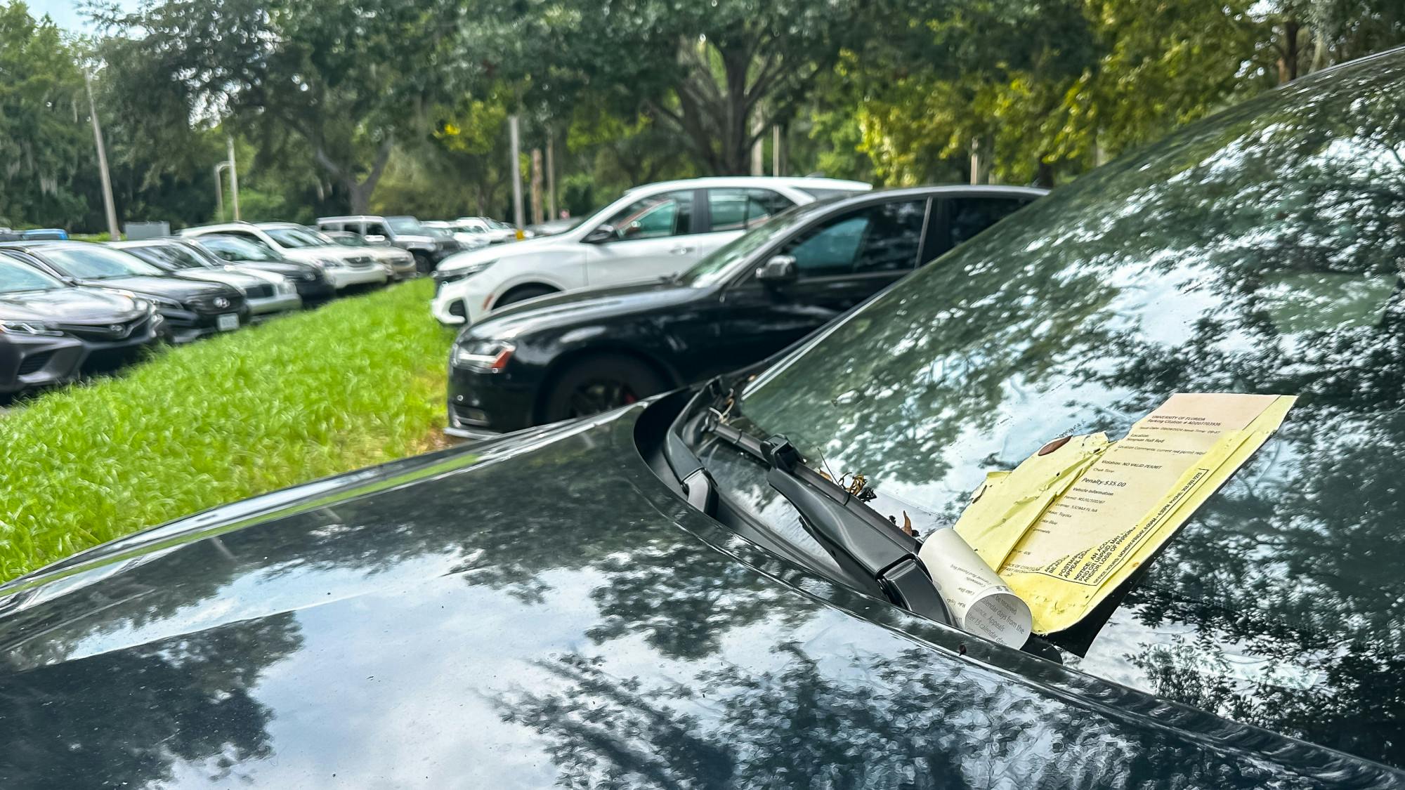 A week-old parking ticket sits on a student&#x27;s windshield by Flavet Field on Sunday, Sept. 15, 2024.