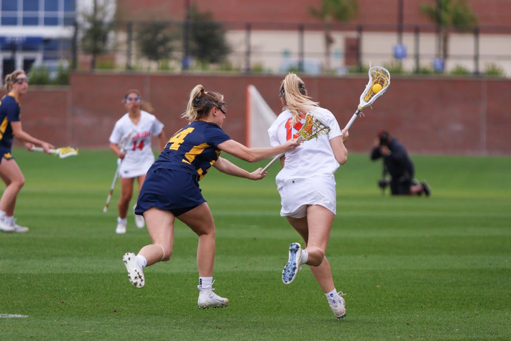 Florida attacker Maggi Hall runs with the ball in her crosse in the Gators' 17-8 win against the No. 18 Michigan Wolverines Sunday, Feb. 12, 2023.
