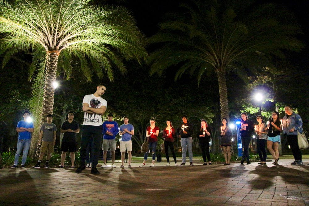 Matan Ozery, a 22-year-old UF alumnus and Marjory Stoneman Douglas High School graduate speaks about his experience at Stoneman Douglas High at the UF Remembers Douglas Vigil held on the Plaza of the Americas, in which 40 people attended Friday night. “You’re not alone in that school. You’re not alone in that community,” he said. 