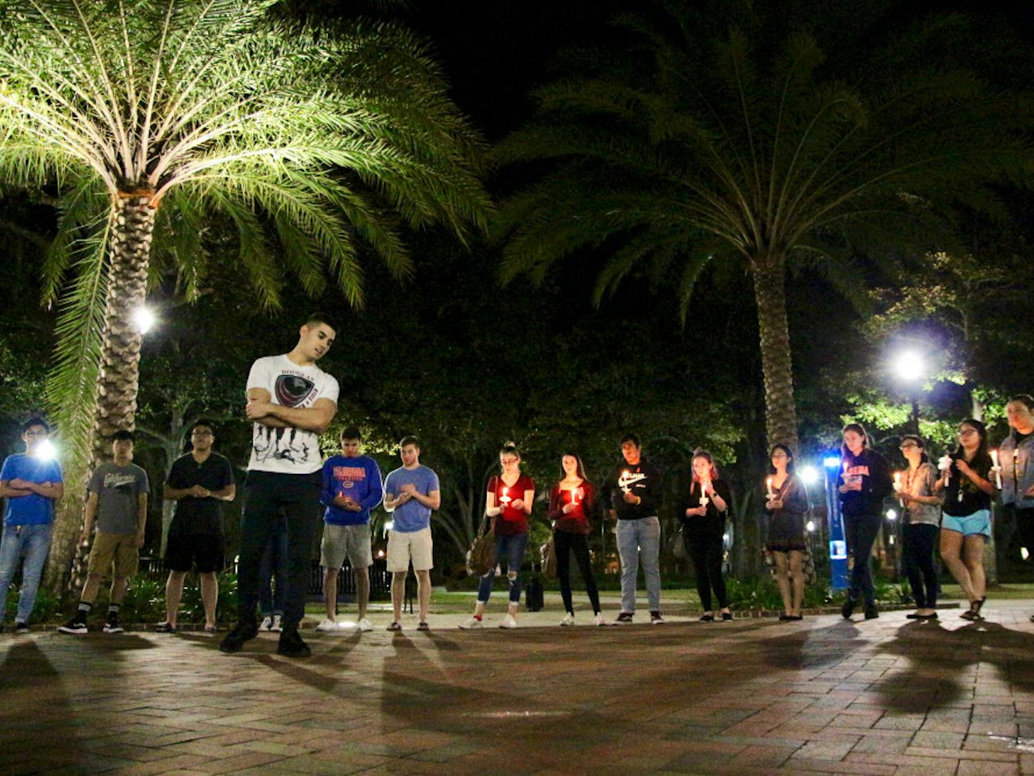 Matan Ozery, a 22-year-old UF alumnus and Marjory Stoneman Douglas High School graduate speaks about his experience at Stoneman Douglas High at the UF Remembers Douglas Vigil held on the Plaza of the Americas, in which 40 people attended Friday night. “You’re not alone in that school. You’re not alone in that community,” he said.