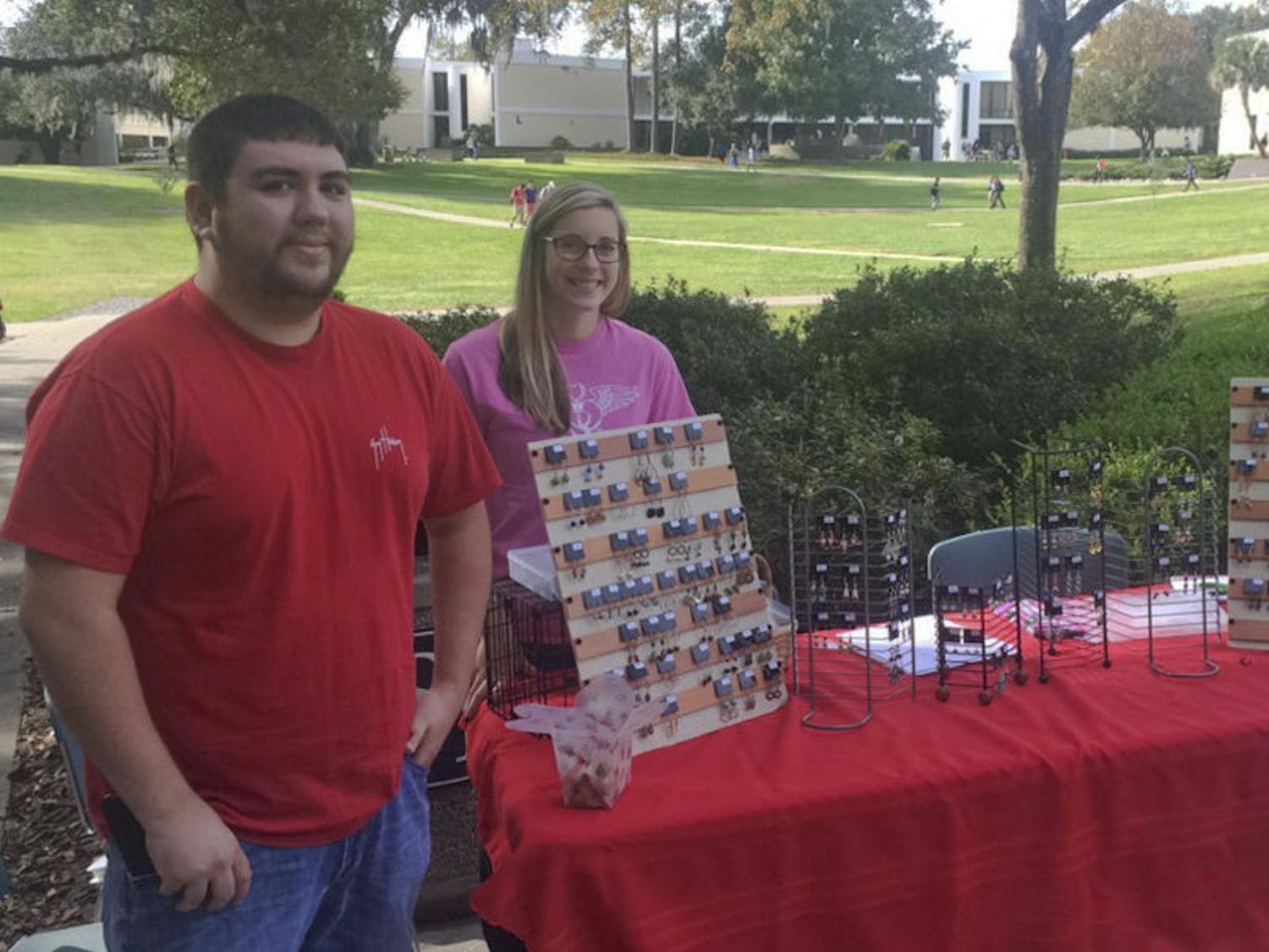 Tyler Welz (left), a 22-year-old Santa Fe nursing senior, and Caroline Lewis, a 21-year-old Santa Fe nursing senior, sell earrings on Nov. 30, 2015, outside Santa Fe’s food court to fund a trip to the Nursing Student Association's annual convention in Orlando. The earring sale ends today at 2 p.m.