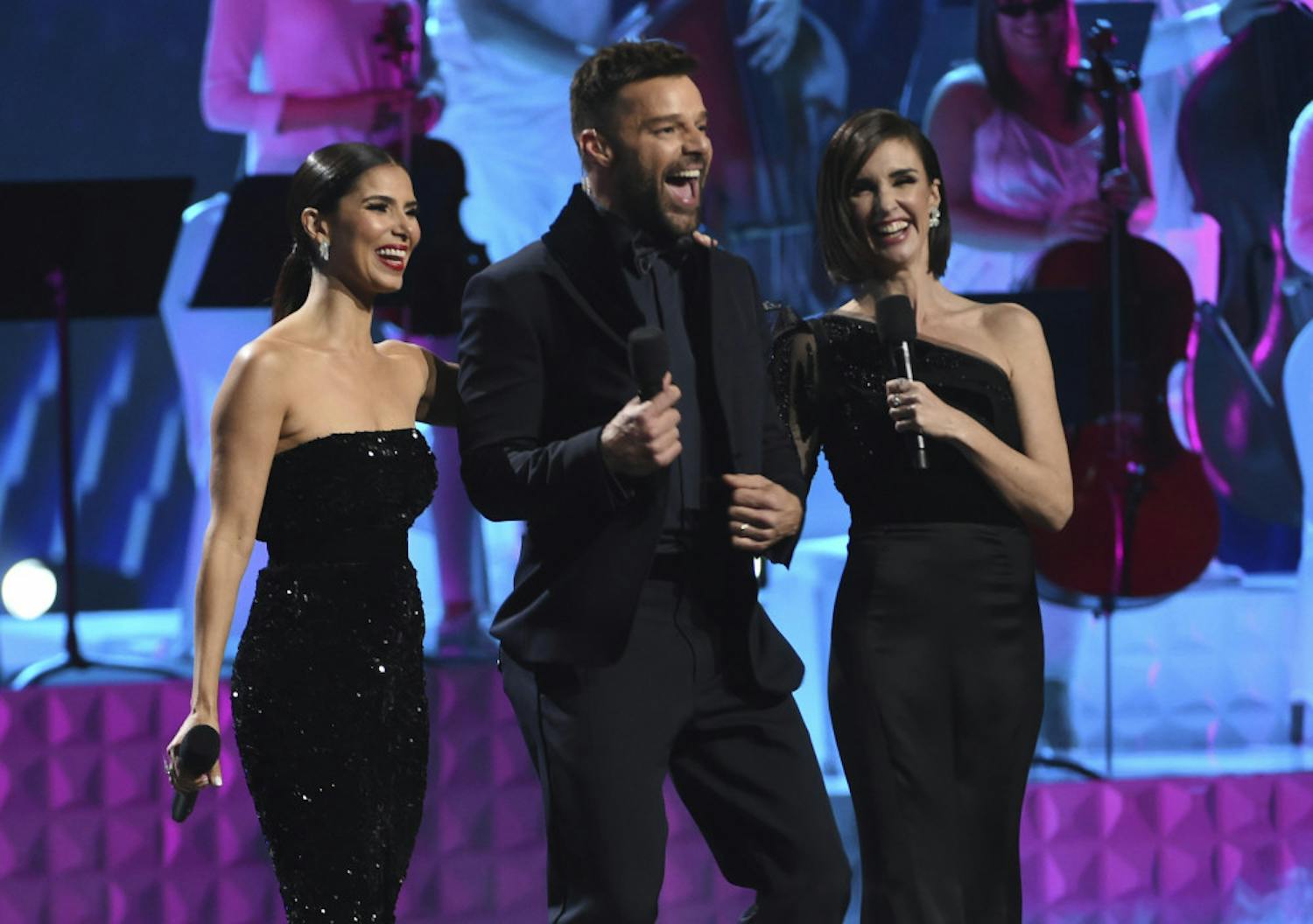 Hosts Roselyn Sanchez, from left, Ricky Martin and Paz Vega speak at the conclusion of the 20th Latin Grammy Awards on Thursday, Nov. 14, 2019, at the MGM Grand Garden Arena in Las Vegas. (AP Photo/Chris Pizzello)