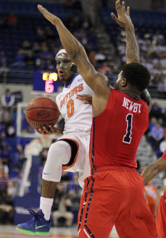 UF's Kasey Hill (0) looks to pass the ball around Ole Miss' Martavious Newby (1) during the Gators' win against the Rebels on Feb. 9, 2016, in the O'Connell Center.