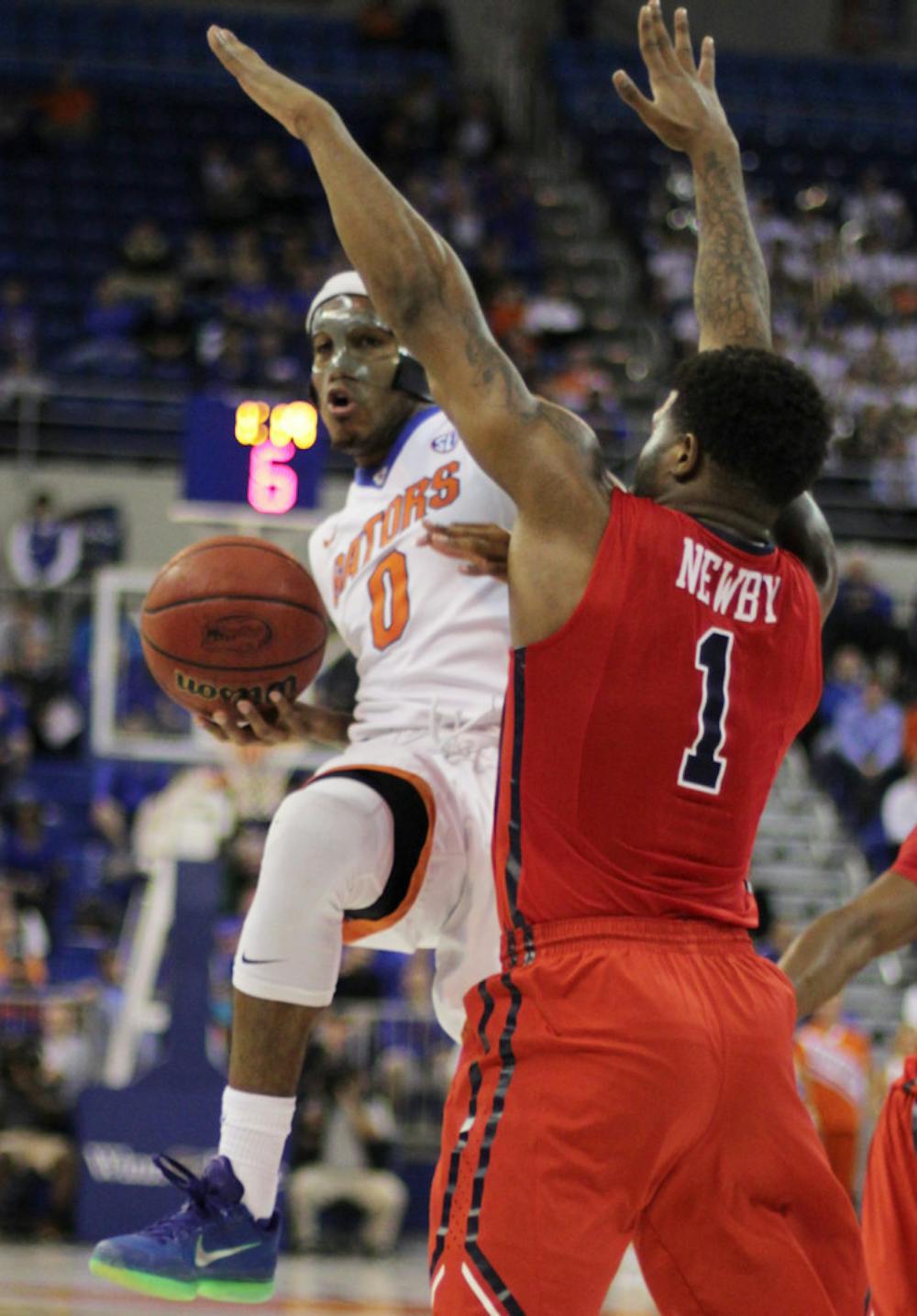 <p>UF's Kasey Hill (0) looks to pass the ball around Ole Miss' Martavious Newby (1) during the Gators' win against the Rebels on Feb. 9, 2016, in the O'Connell Center.</p>