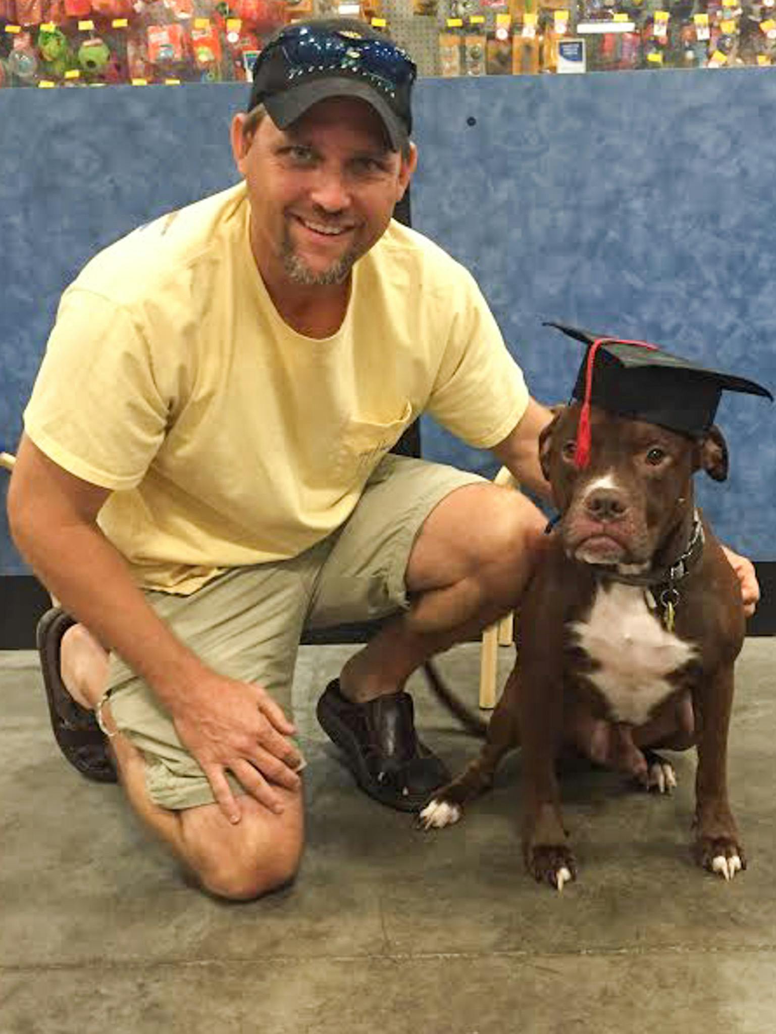 Jimmy Ritten, a 42-year-old U.S. Navy veteran, poses with his service dog, Cody, after the pit bull’s graduation from Phoenix Animal Rescue’s veteran service dog program. Inspired by Ritten’s difficulty finding a service dog elsewhere, the Gainesville-based animal shelter will shut down on Dec. 31 and start the Pets and Patriots Foundation to focus on finding service dogs for veterans.