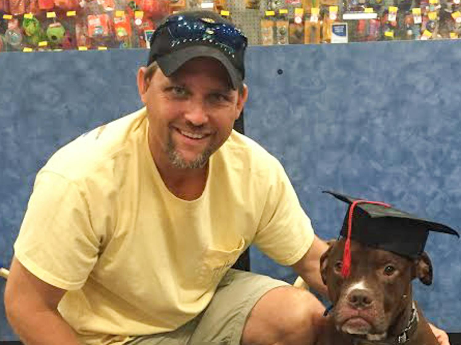 Jimmy Ritten, a 42-year-old U.S. Navy veteran, poses with his service dog, Cody, after the pit bull’s graduation from Phoenix Animal Rescue’s veteran service dog program. Inspired by Ritten’s difficulty finding a service dog elsewhere, the Gainesville-based animal shelter will shut down on Dec. 31 and start the Pets and Patriots Foundation to focus on finding service dogs for veterans.
