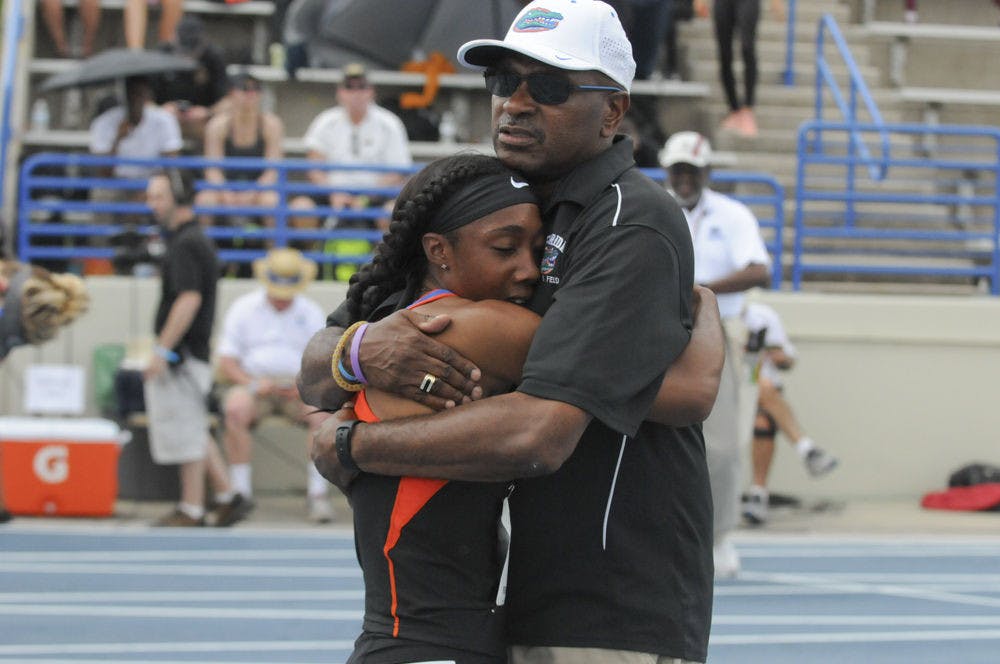 Robin Reynolds hugs coach Mike Holloway after winning the 400-meter dash at Friday's Pepsi Florida Relays on the Percy Beard Track.