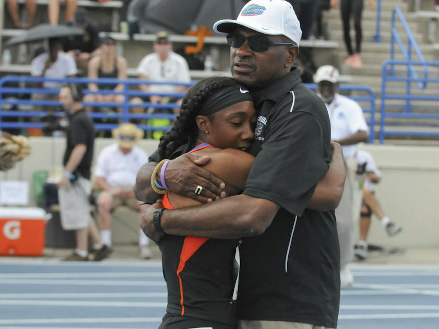 Robin Reynolds hugs coach Mike Holloway after winning the 400-meter dash at Friday's Pepsi Florida Relays on the Percy Beard Track.