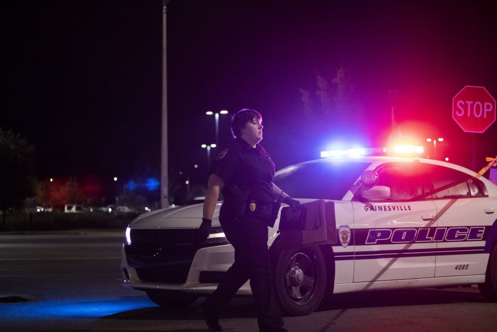 Investigator Boyett approaches the scene Sunday night at the Jersey Mike’s in Butler Plaza. 