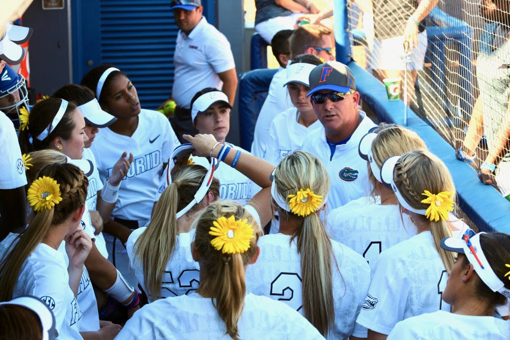 <p>Tim Walton speaks with his players in the dugout during Florida's 5-0 win against Georgia on April 8, 2017, at Katie Seashole Pressly Stadium.</p>