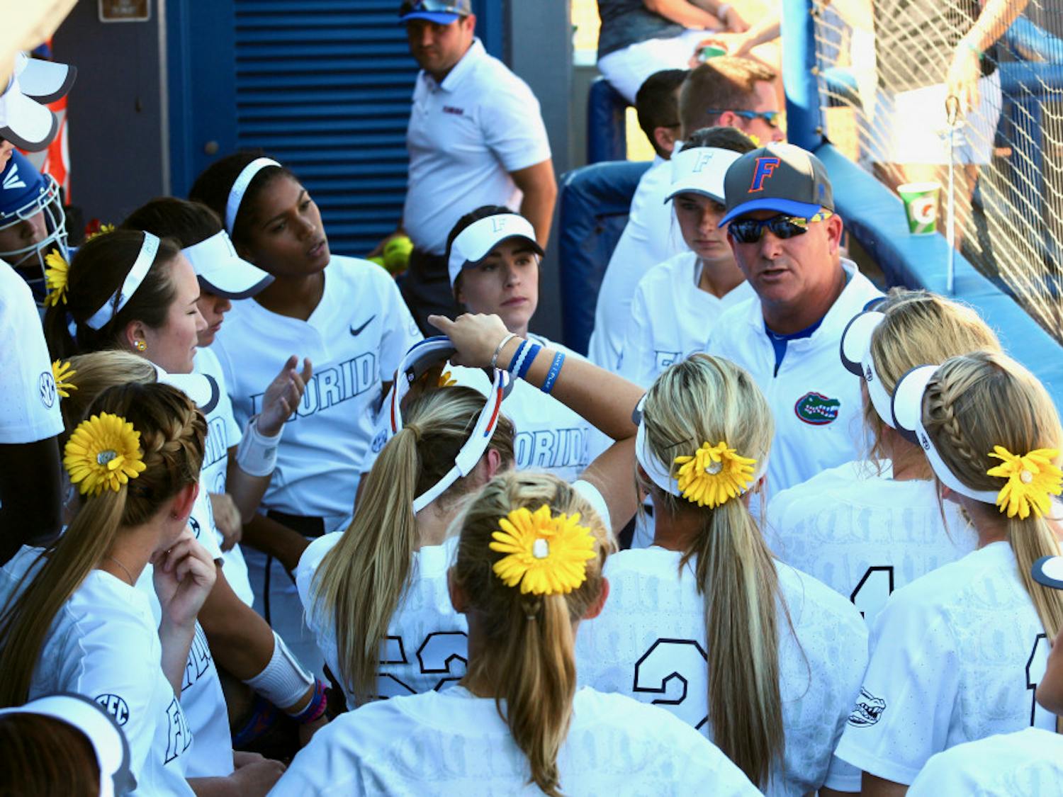 Tim Walton speaks with his players in the dugout during Florida's 5-0 win against Georgia on April 8, 2017, at Katie Seashole Pressly Stadium.