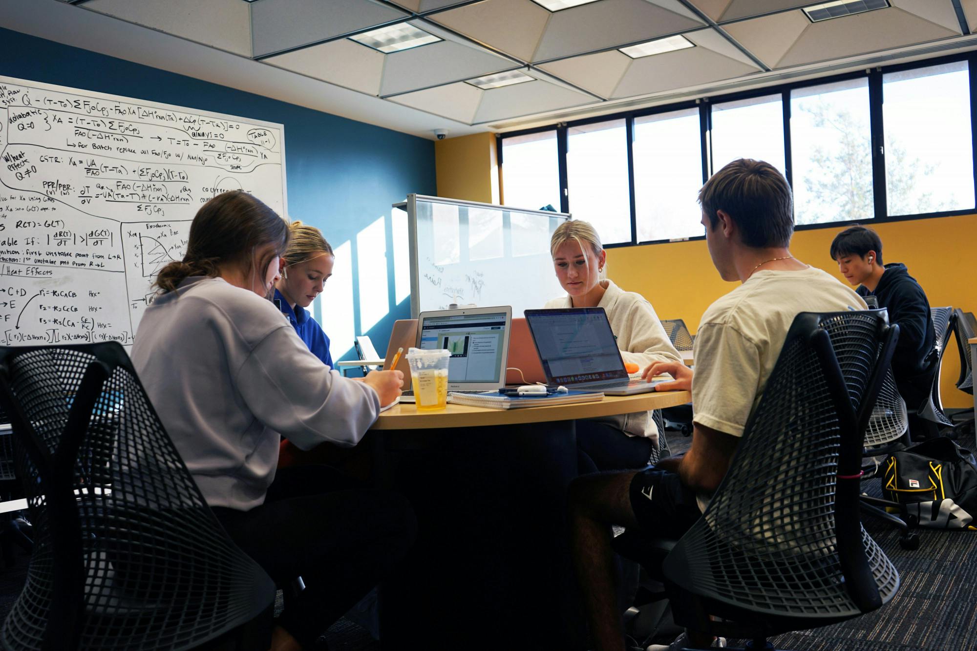 From left to right, Sarah Toomey, Carina Swenson, Madison Hendrikse and Kyle Hopwood gather around a table at Marston Science Library to study Monday, Jan. 16, 2023. 