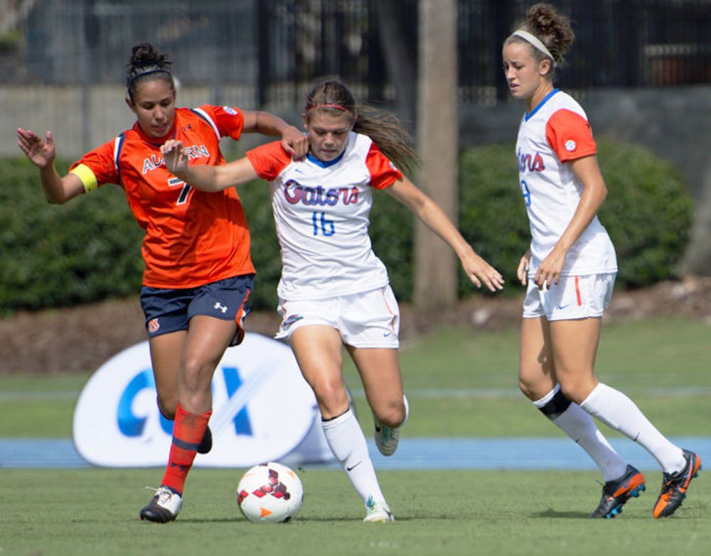 <p>Liz Slattery battles for the ball during Florida’s 3-0 victory against Auburn on Sunday in James G. Pressly Stadium. Slattery recorded her first career assist against the Tigers.</p>