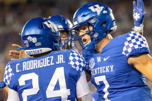 Kentucky quarterback Will Levis (7) and Chris Rodriguez Jr. (24) celebrate together during a game. Photo by Jack Weaver (Kentucky Kernel).