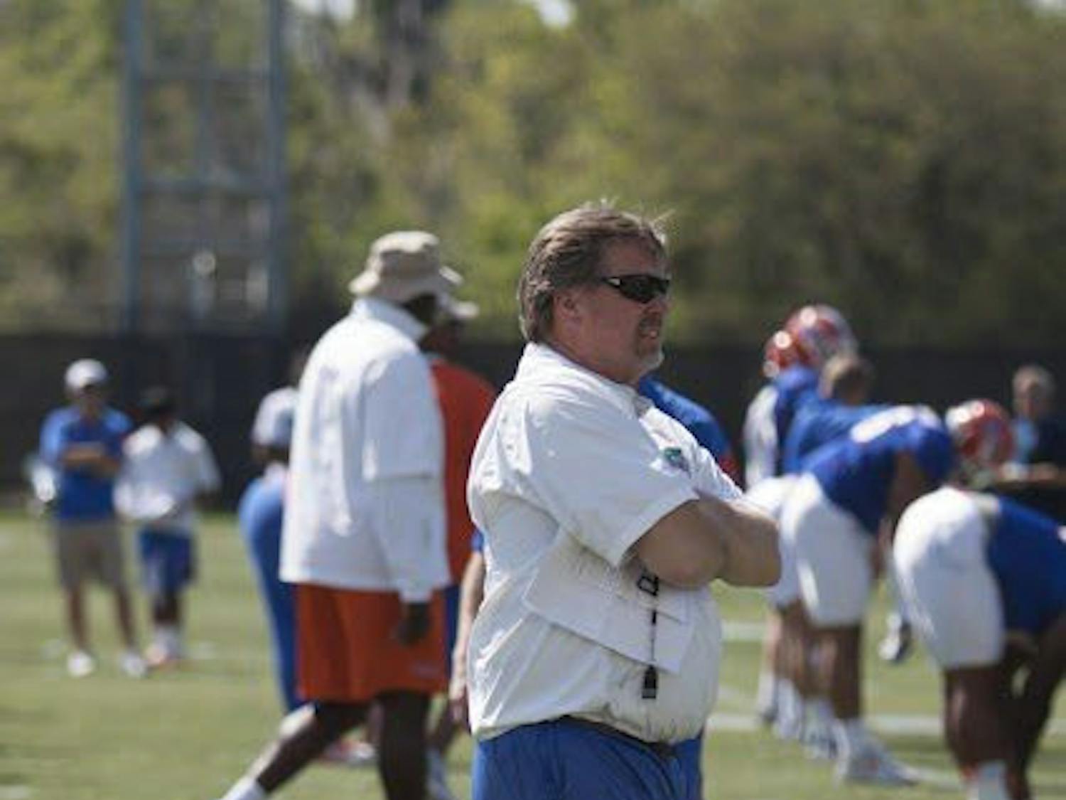 UF Jim McElwain walks between rows of players during a spring practice at the Sanders Practice Field on March 22, 2017. 