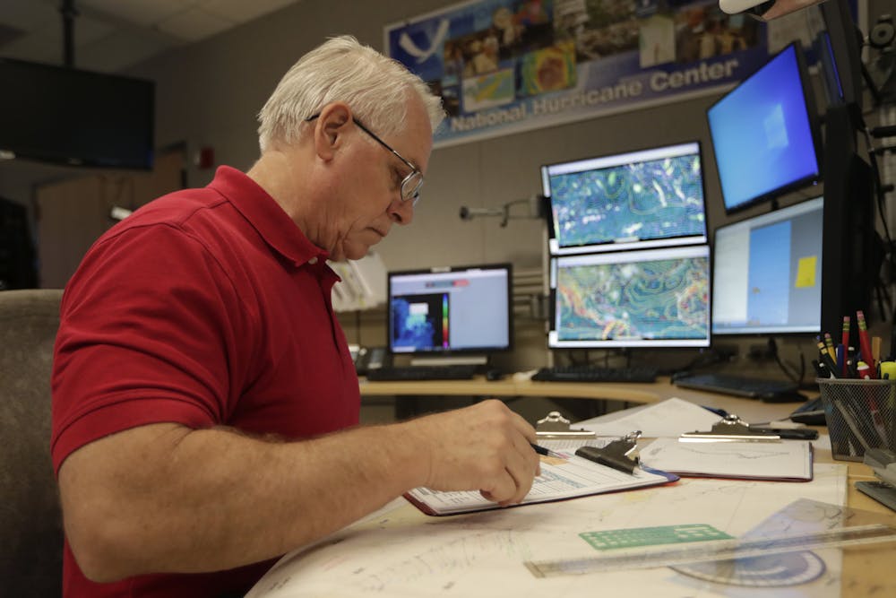 <p>Senior hurricane specialist Stacy Stewart monitors the progress of Tropical Storm Dorian at the National Hurricane Center, Tuesday, in Miami.</p>