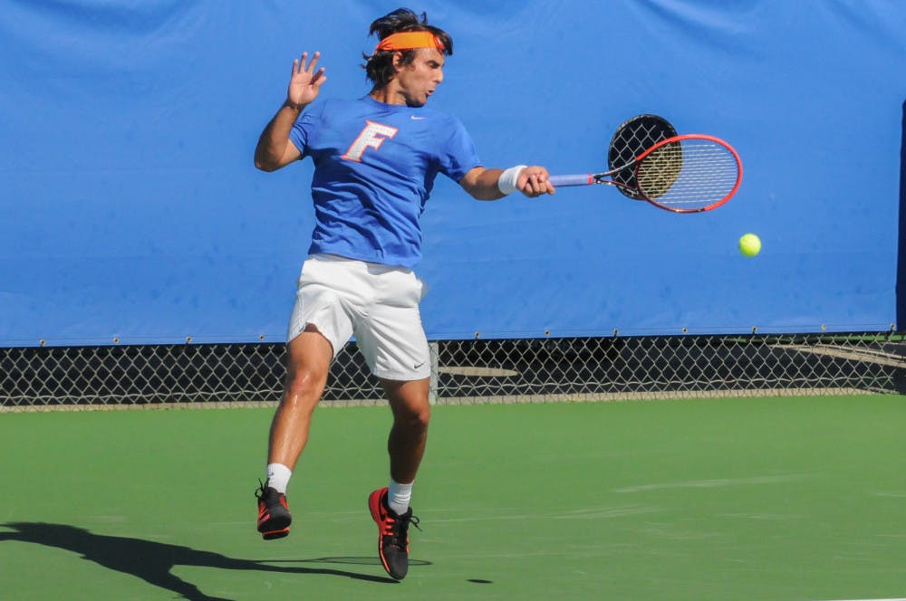 Diego Hidalgo returns a serve during Florida's 6-1 win over Troy on Jan. 17, 2016, at the Ring Tennis Complex.