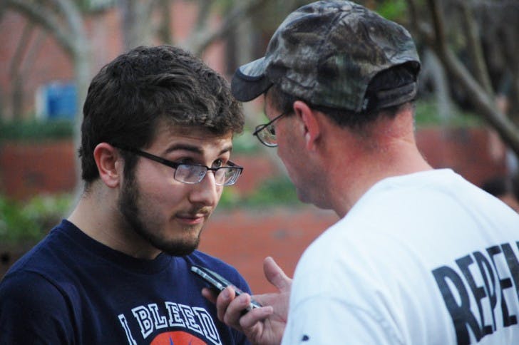 Christian Chessman, 19, and Matt Bourgault, a self-proclaimed evangelical preacher, engage in an altercation on Turlington Plaza on Thursday afternoon.