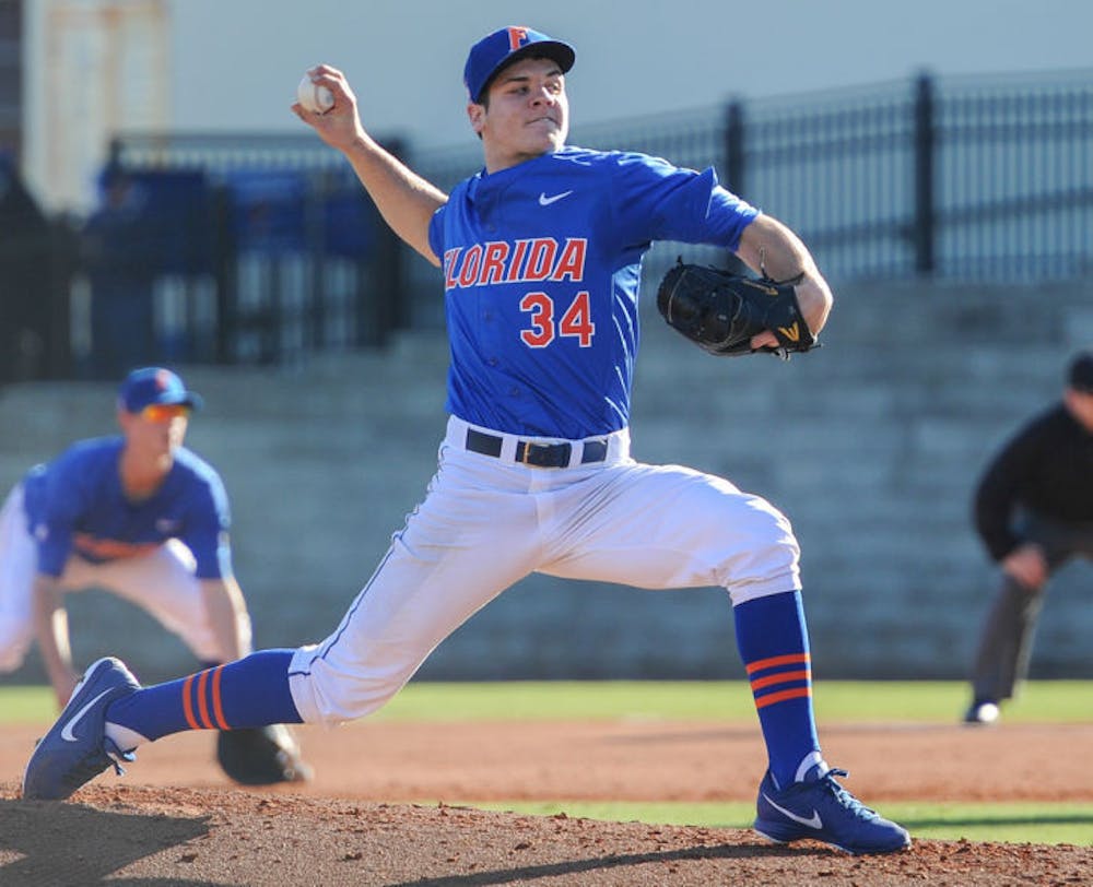 <p>Brett Morales pitches during Florida’s loss against Maryland on Feb. 15, 2014, at McKethan Stadium.</p>