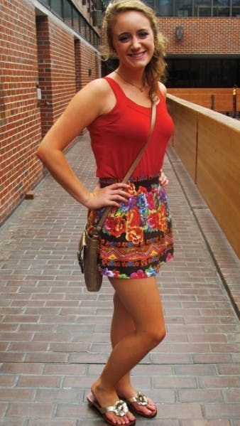UF junior Rita Carter wears a bright red tank top tucked into a patterned miniskirt and pairs her outfit with metallic accessories. The telecommunications major said she was going for a casual and comfortable outfit.