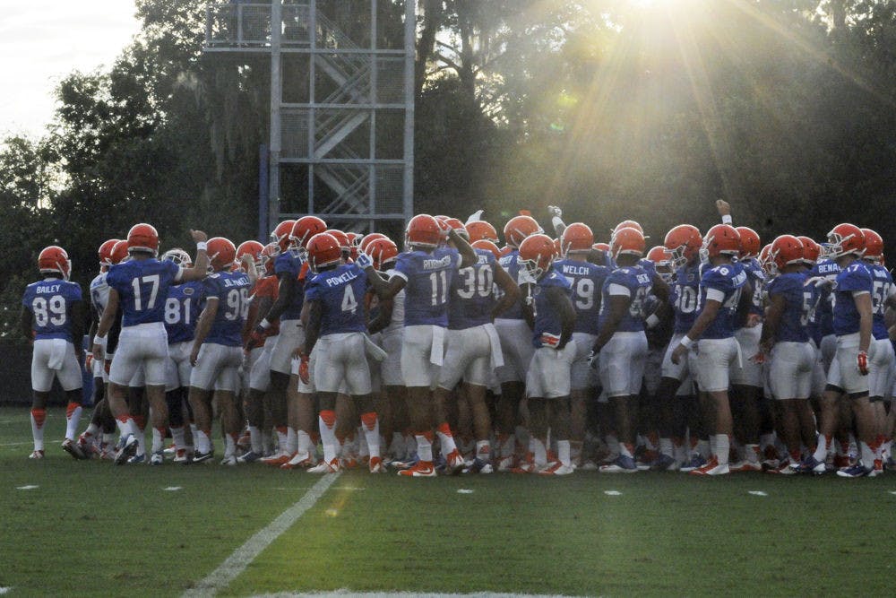 <p>Florida football players huddle at practice at the Sanders Practice Field Aug. 31, 2015.</p>