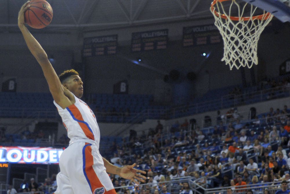 UF forward Devin Robinson rises for a dunk during Florida's 89-42 exhibition win against Palm Beach Atlantic.