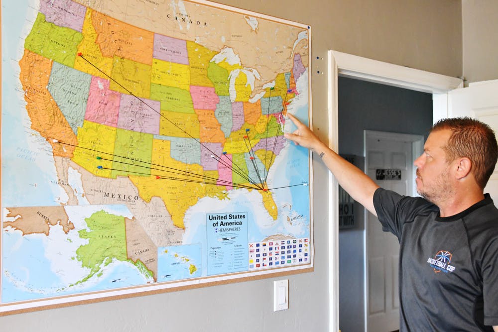 <p dir="ltr">Pointing at a map dotted with colored pushpins, Gainesville Police Officer Bobby White shows where he has delivered basketball hoops and balls as part of his Basketball Cop Foundation.</p>