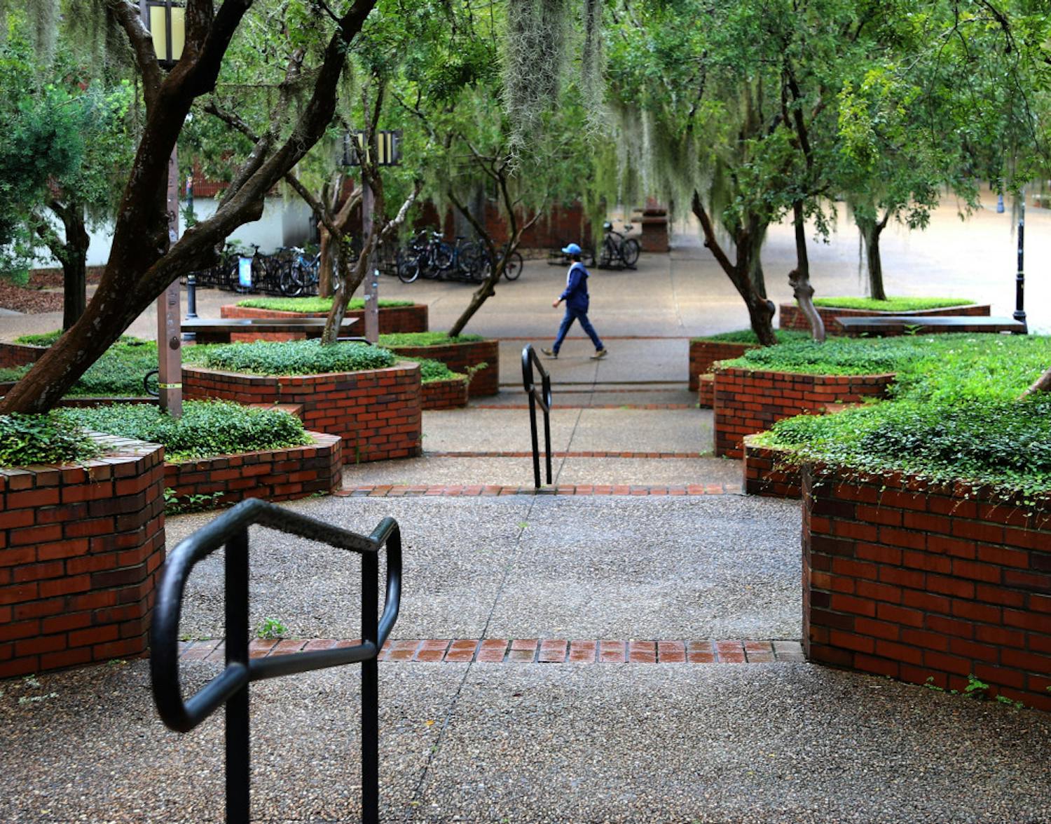 A lone man is seen walking through Turlington Plaza at UF in Gainesville, Fla., on August 31, 2020. The plaza, which is usually filled with people, remained relatively bare on the first day of fall classes. 