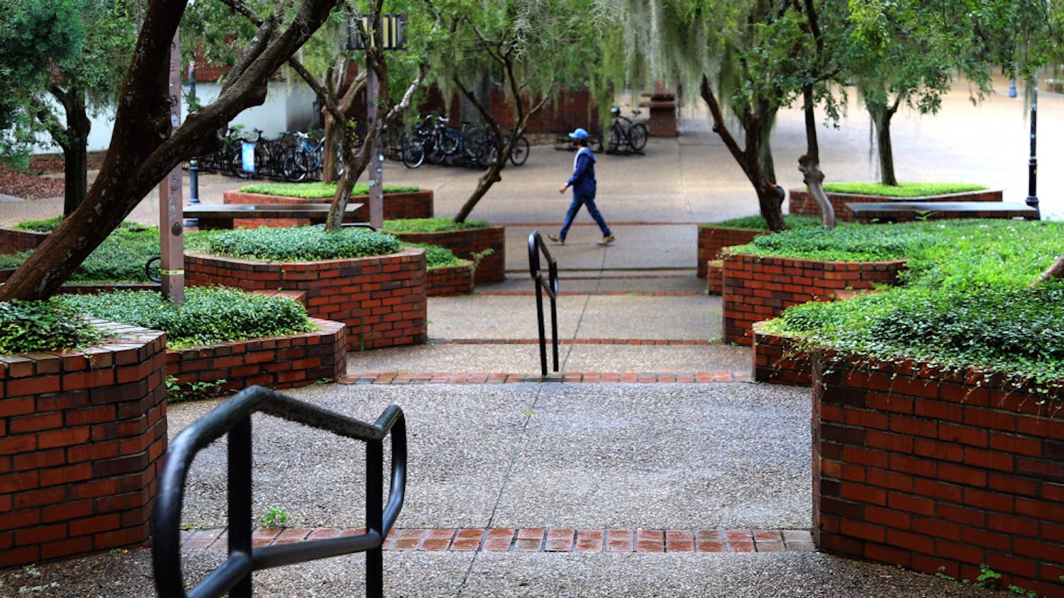 A lone man is seen walking through Turlington Plaza at UF in Gainesville, Fla., on August 31, 2020. The plaza, which is usually filled with people, remained relatively bare on the first day of fall classes. 