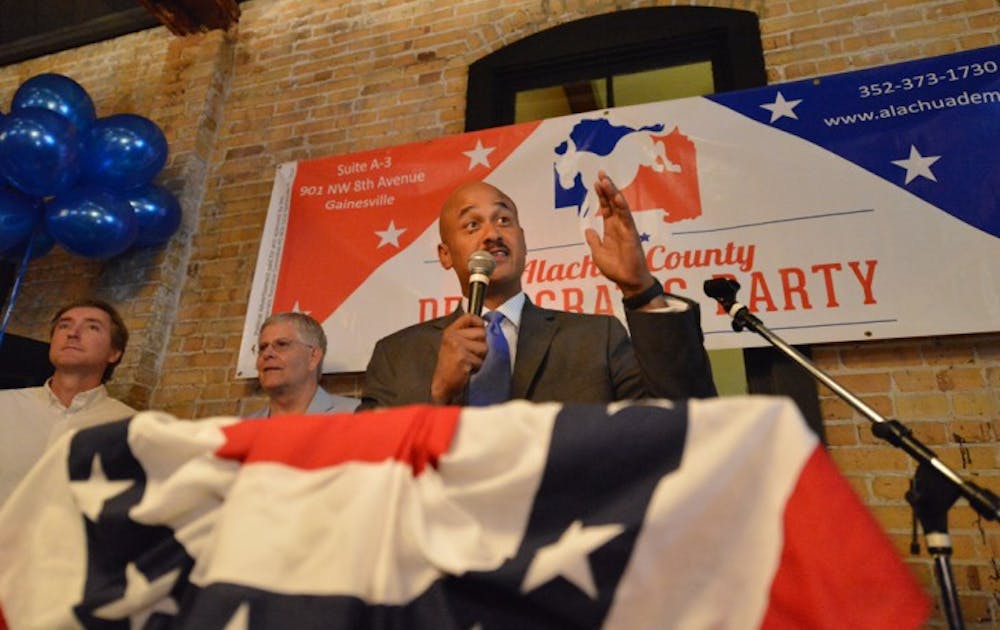 <p>Charles “Chuck” Chestnut addresses Democratic supporters after securing a seat on the Alachua County Commission. Chestnut and two other Democratic candidates who won seats on the commision learned of their victories Tuesday night at Cellar 12 downtown.</p>